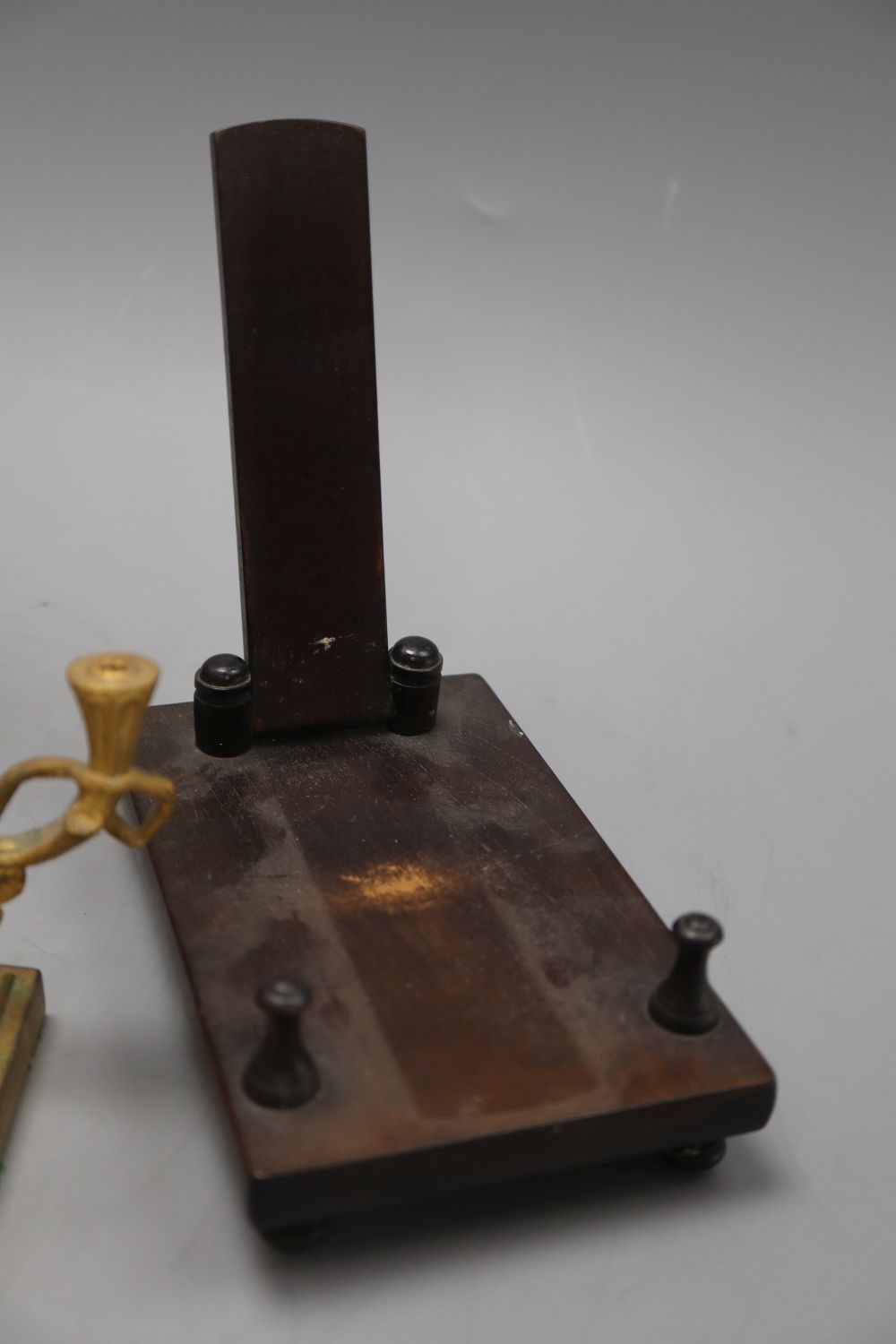 A William IV penwork tea caddy, a pair of ormolu Bacchanalian cherub candlesticks, lacking sconces and a hardwood dish stand